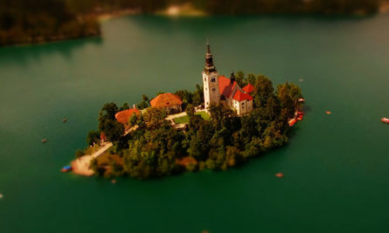 Drone view of island on Lake Bled, Slovenia in tilt-shift video